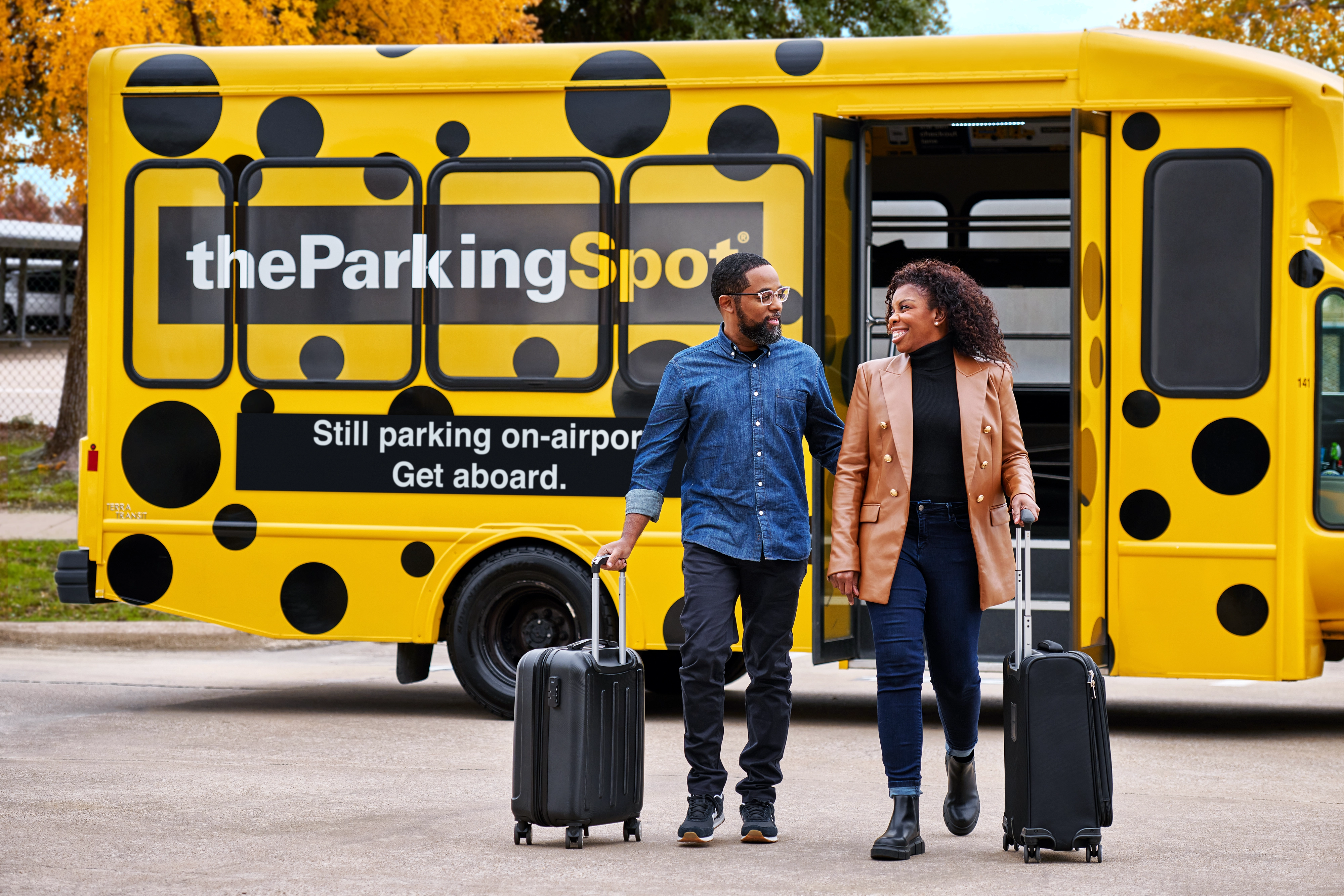 The Parking Spot airport shuttle driver helps a guest load luggage