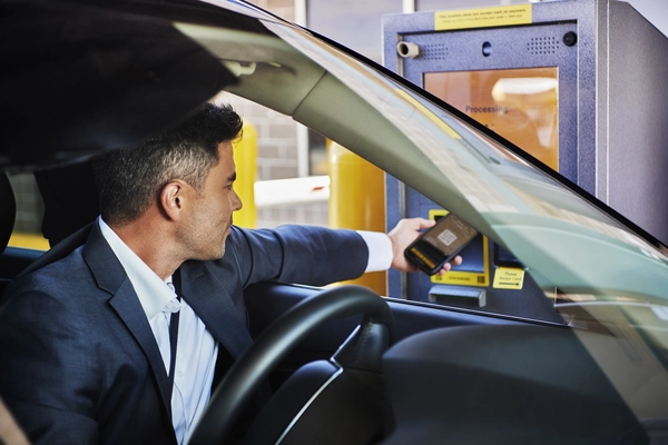 A guest scans their reservation QR code at The Parking Spot entry kiosk.