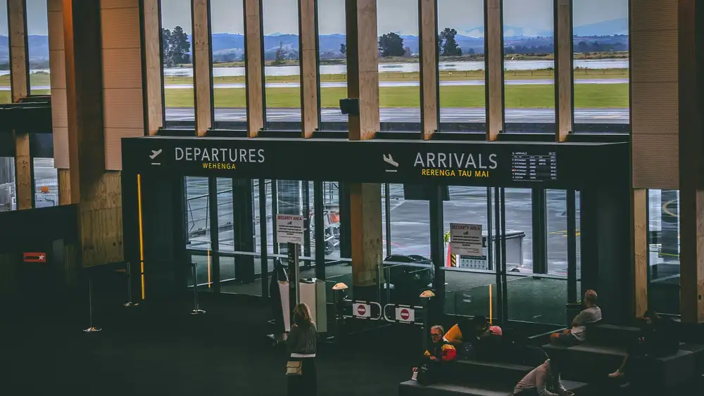 An airport interior showing doors to Arrivals and Departures areas.