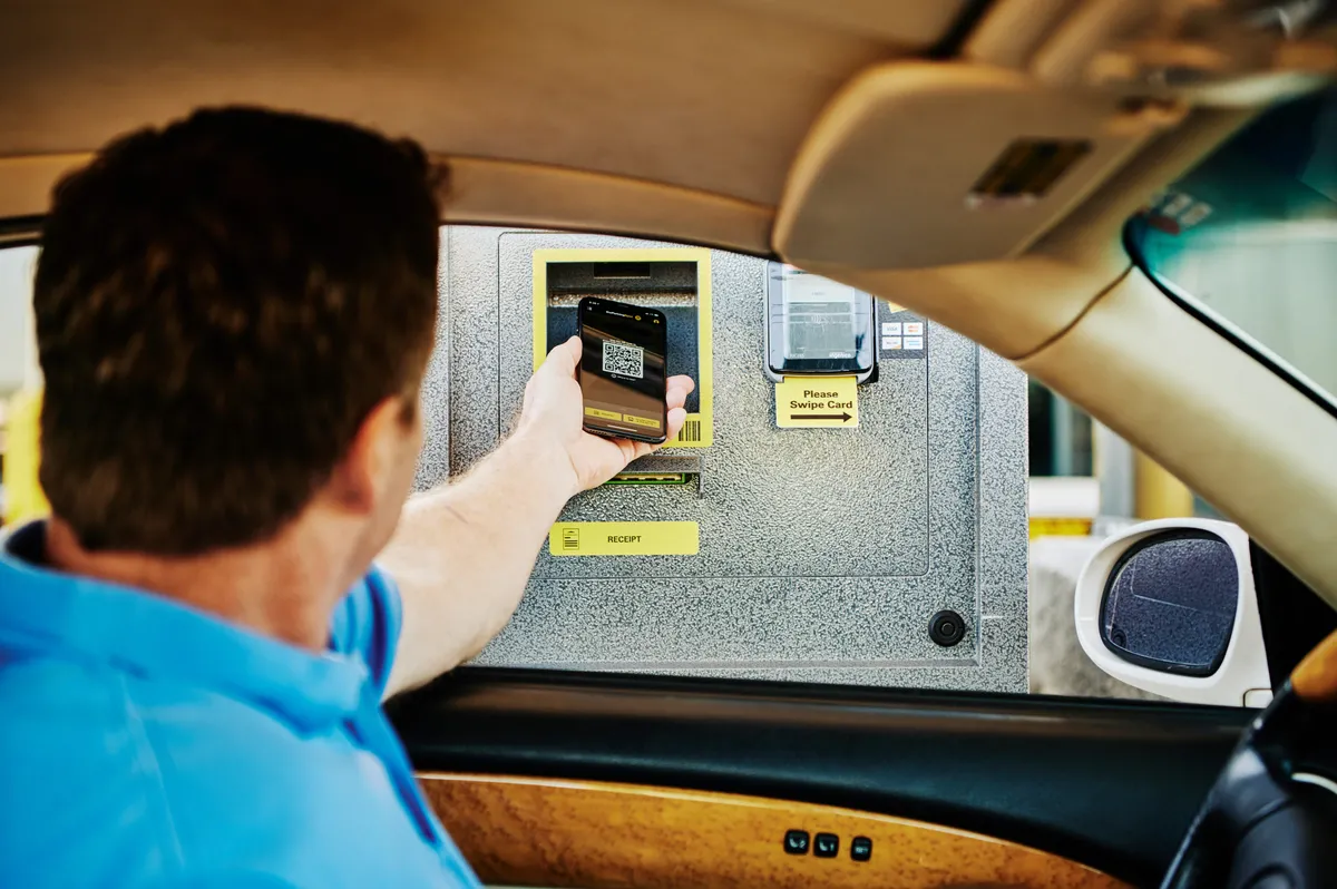 Spot Club member scans into airport parking with a smart phone app.