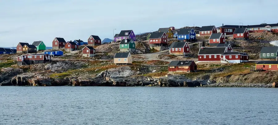 Colorful houses on the shore during summer in Nuuk, Greenland, viewed from the bay.